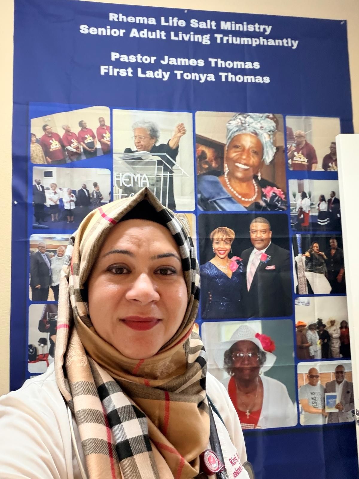 Dr. Rizvi in front of the Rhema Life Salt Ministry banner for the church's senior adults