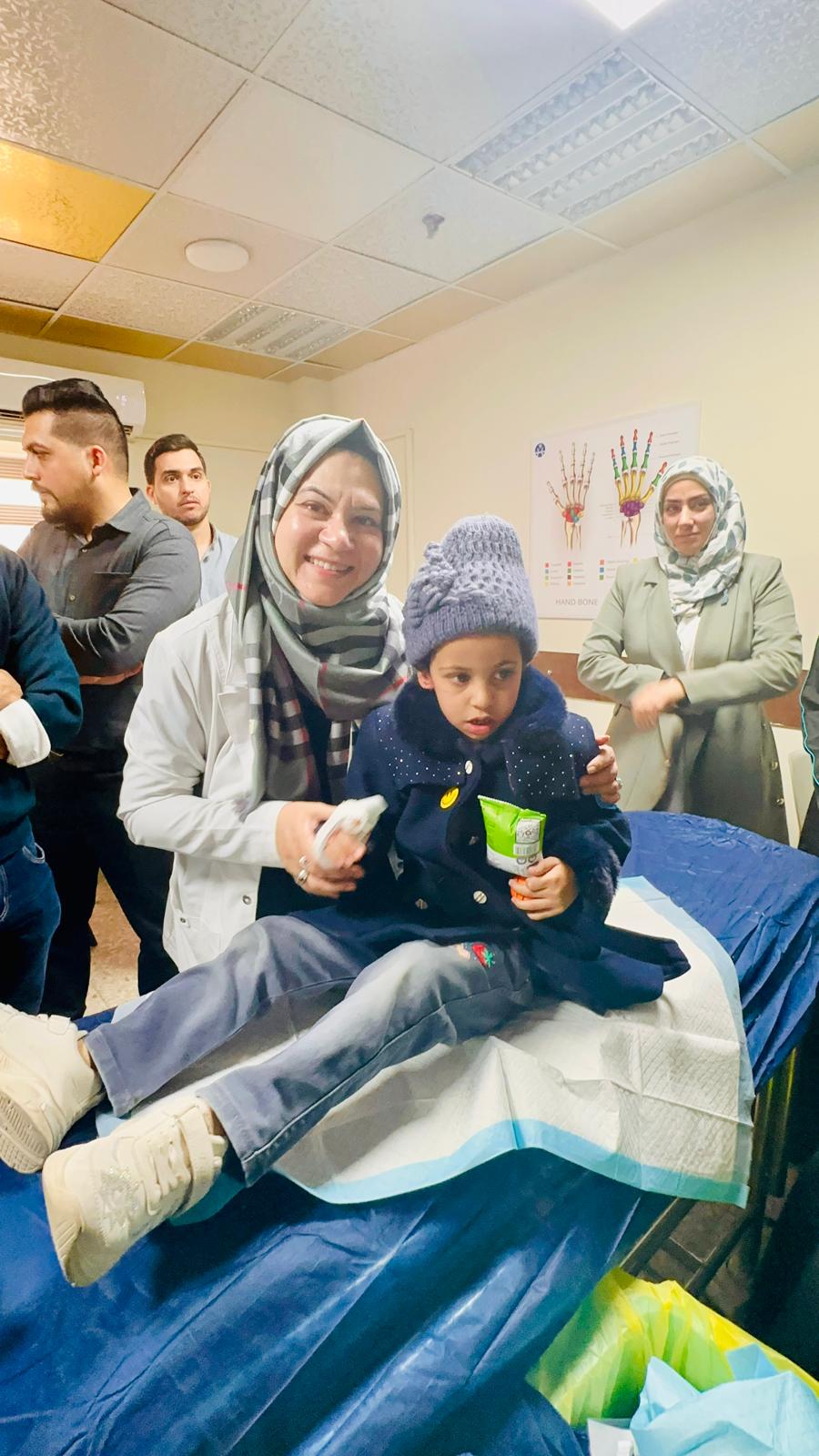 Dr. Rizvi with a young patient during a volunteer medical mission